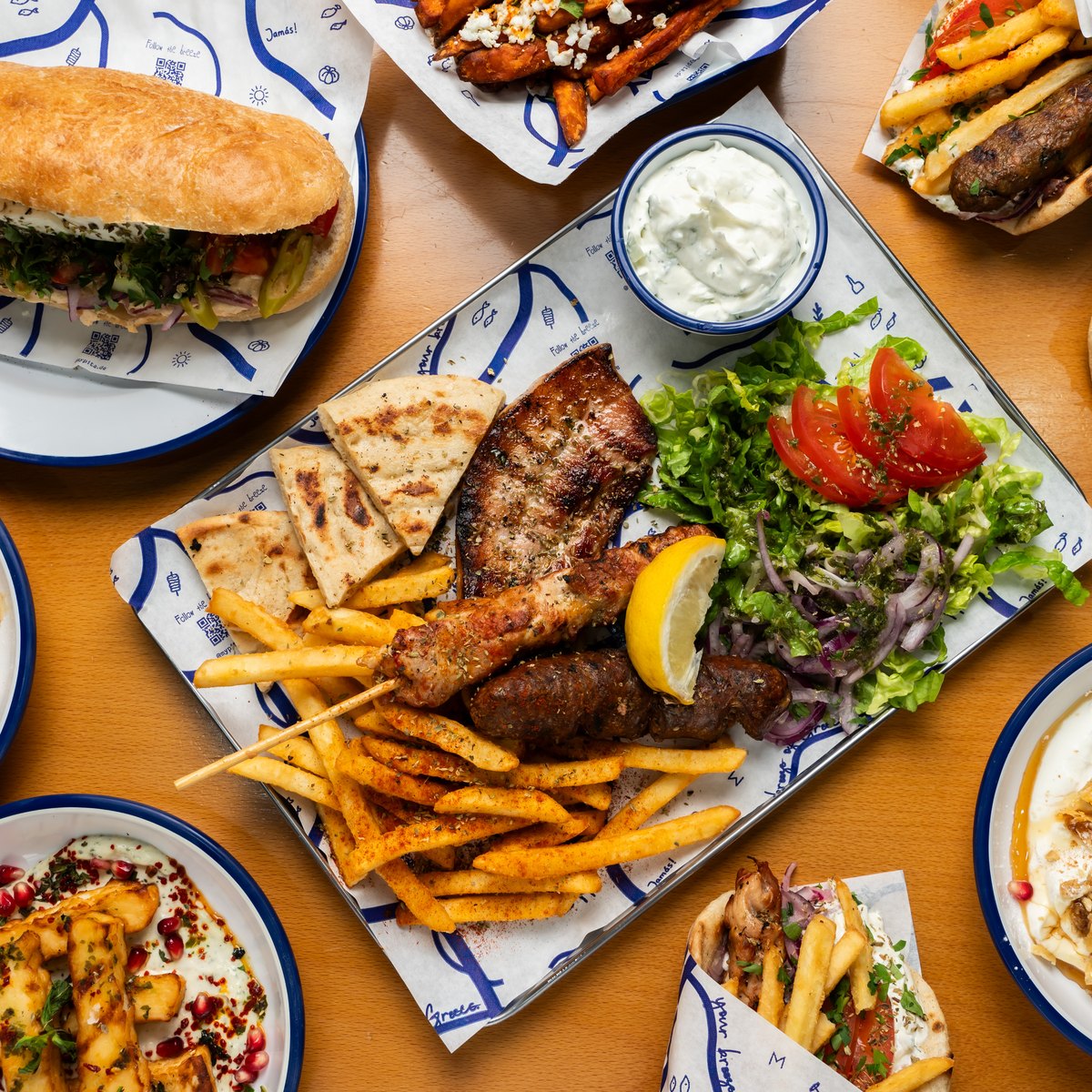 Greek grill platter with gyros, souvlaki, fries and tzatziki